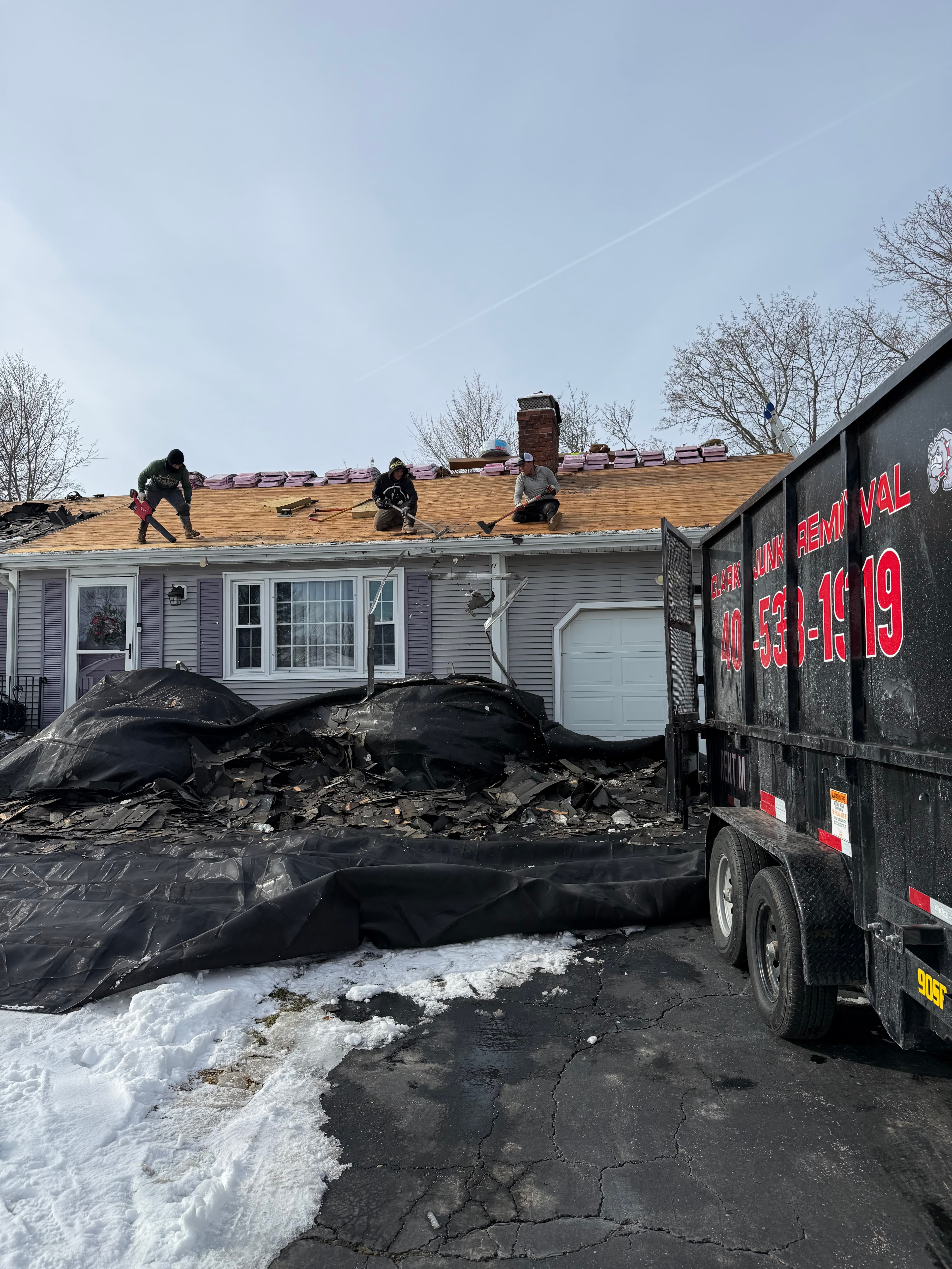 Roofing and demolition debris cleared by Clark's team