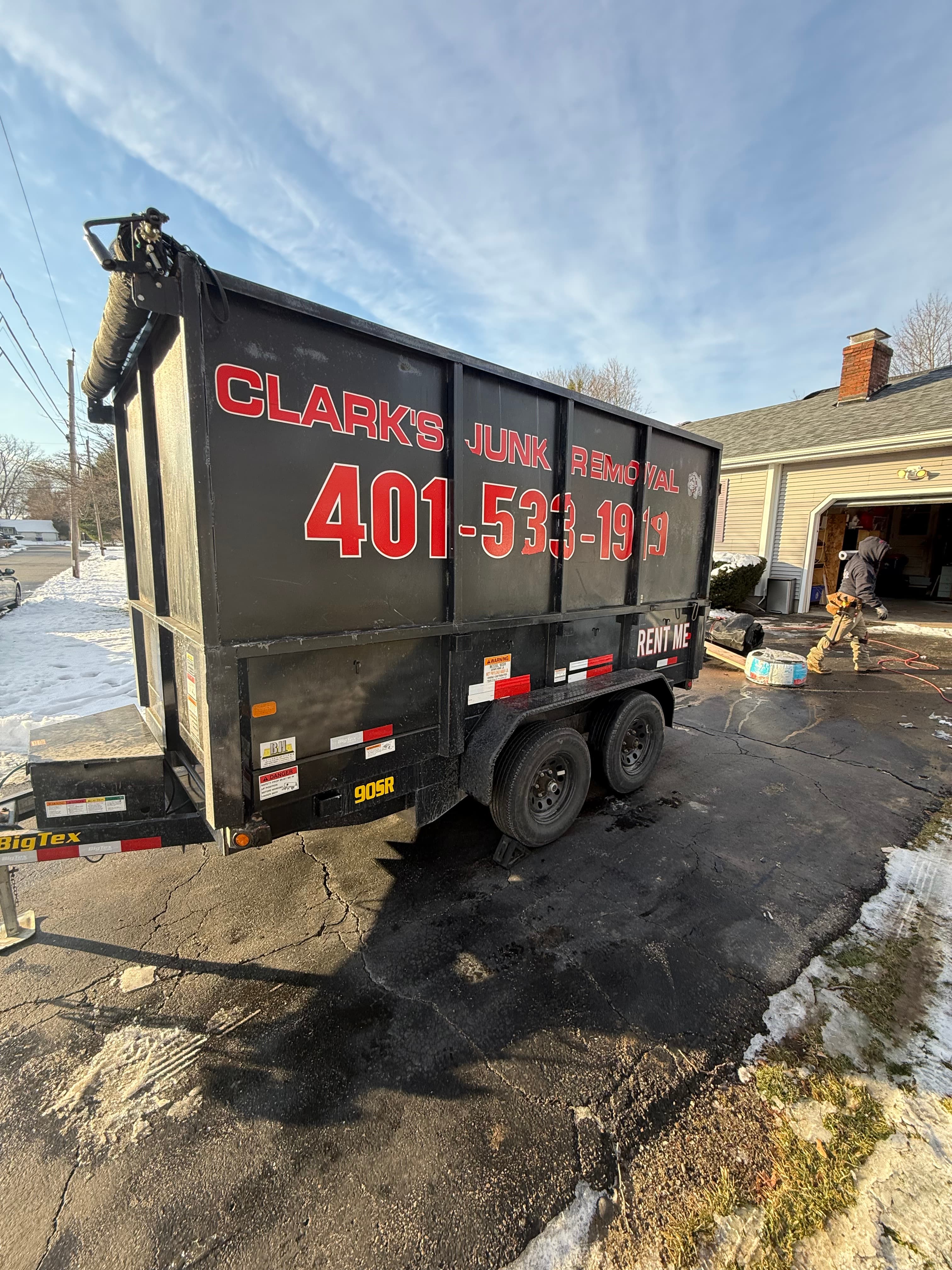 Clark's branded dumpster trailer parked on a job site